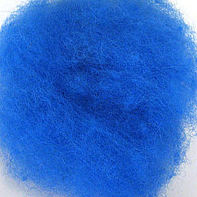 A close-up view of a fluffy mass of bright blue fibers gathered together in a loose, airy clump, resembling Harrisville Dyed & Carded Wool Fiber from Harrisville Designs. The texture appears soft and lightweight, capturing the essence of heathered colors often used for felting wool projects.