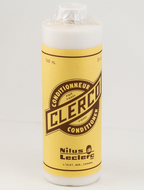 A bottle of Clerco Fiber Conditioner by Leclerc Looms. The container is yellow with brown text and holds 540 ml of product. The label mentions four fibers, including wool, and references L'Islet, Quebec, Canada. A plastic seal covers the top of the bottle.