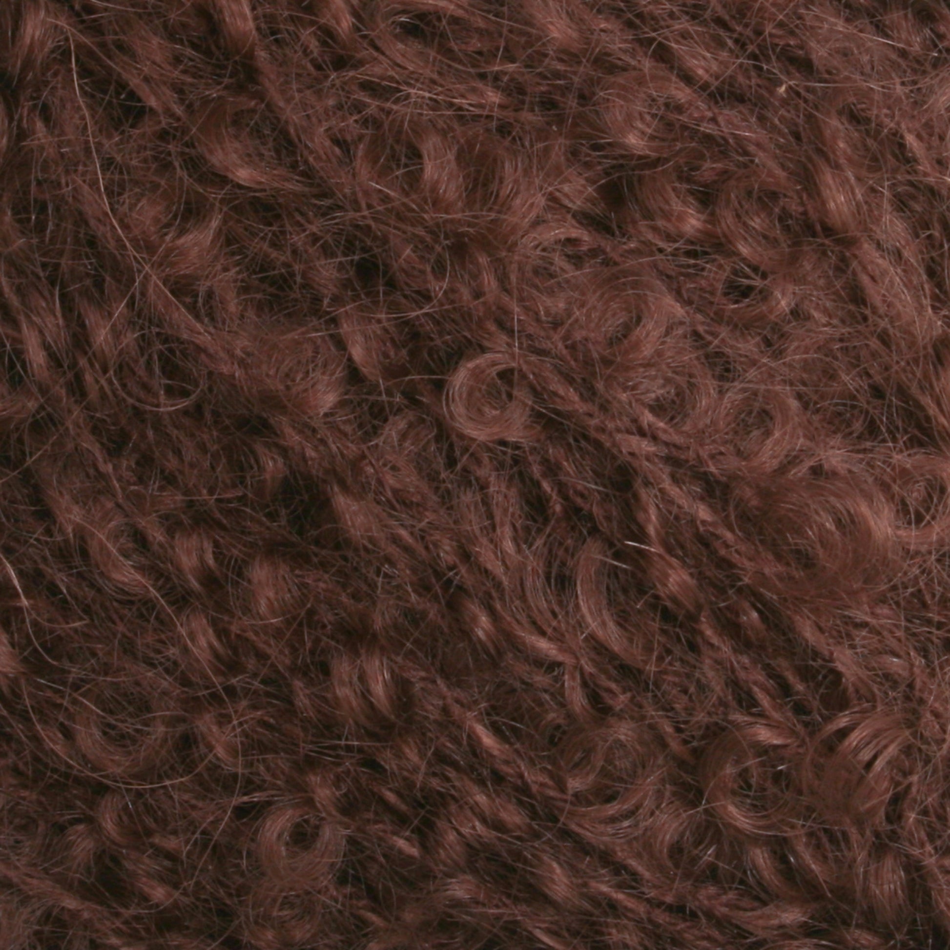 Close-up image of curly hair in a rich, reddish-brown color. The texture appears dense and tightly coiled, reminiscent of Victorian Bouclé Mohair Yarn from Caledonian Dye Works, filling the entire frame and showcasing the natural curls and waves.