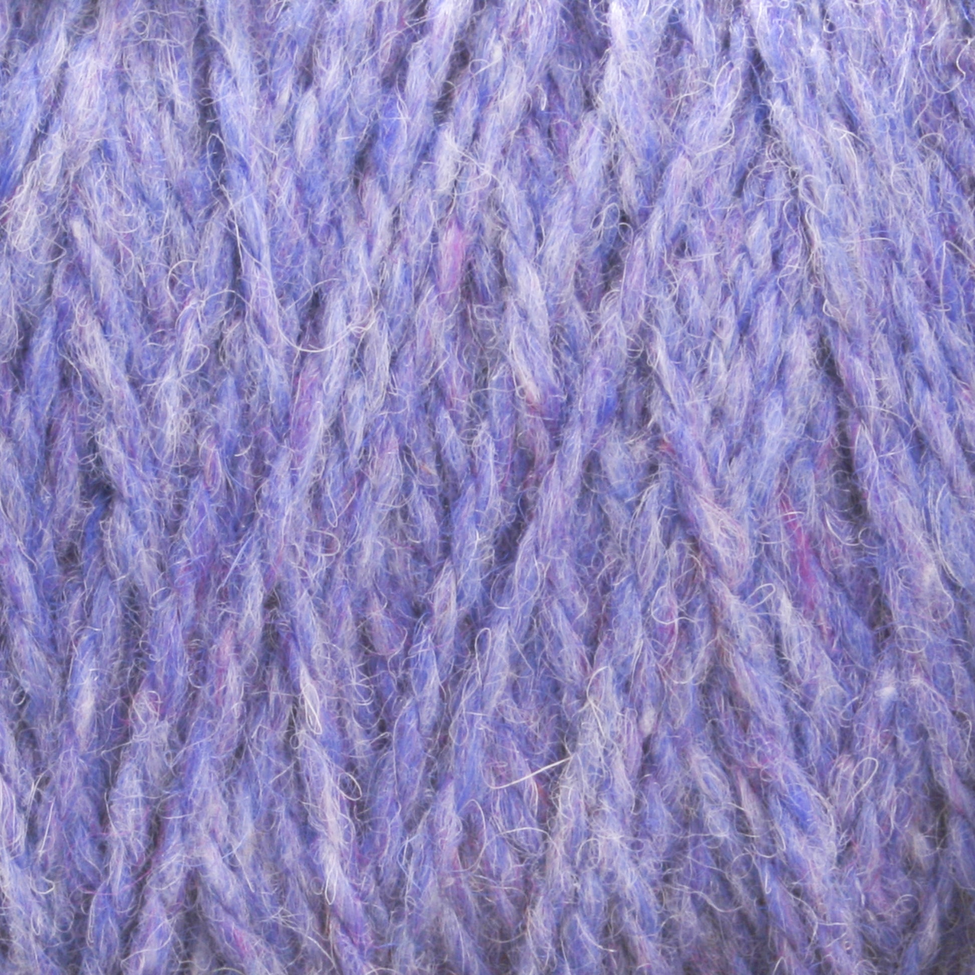 Close-up view of a textured ball of Harrisville Designs' Harrisville Shetland Yarn - Unwashed Cones, featuring various shades of purple with hints of blue and pink. The fibers appear soft and fluffy, showcasing a twisted and intertwined pattern that is ideal for Fair Isle knitting designs.