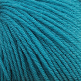 Close-up of a bundle of turquoise Baby Blatt by Anny Blatt yarn from Essentially Felt Studio & Fine Yarn, displaying tightly wound strands. The texture is soft and slightly fuzzy, and the vibrant color stands out prominently. This fingering weight yarn is perfect for delicate projects and is conveniently machine washable.