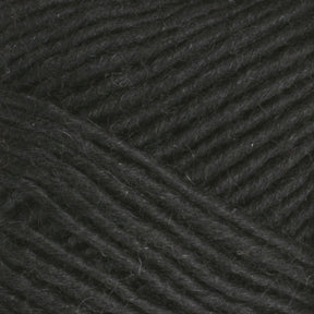 Close-up of Lamb's Pride Worsted Yarn by Brown Sheep, texture shows tightly woven fibers with a slightly rough surface. The strands are thick and parallel, evoking warmth and coziness, ideal for Navajo style weaving or felting projects.