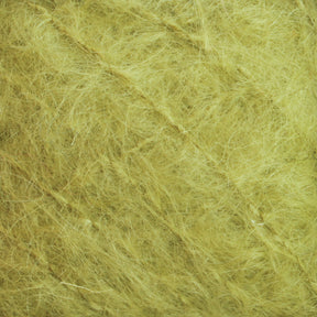 The close-up image showcases the luxurious texture of Caledonian Dye Works' Victorian Brushed Mohair Yarn in a large skein. The intertwined fibers form a dense, chaotic pattern, predominantly pale yellow with subtle shade variations, evoking the intricate quality reminiscent of classic Victorian yarns.