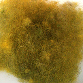 Close-up of tangled, light brown and yellowish fibers forming a fluffy, irregular bundle. The texture appears soft and downy, akin to Harrisville Dyed & Carded Wool Fiber from Harrisville Designs in heathered tones. The background is a neutral, light-colored surface.