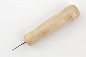 A Basic Rug Hook from Harry Fraser Co. featuring a wooden handle with a smooth, tapered design and a pointed metal tip. The tool is showcased on a plain white background, highlighting the natural wood grain patterns and making it an ideal addition for those seeking functional hooks among their rug hooking supplies.