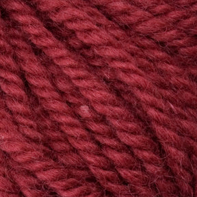 Close-up of the red Halcyon Yarn Classic Rug Wool | Strand by Caledonian Dye Works, showcasing its soft, wooly texture. The tightly twisted fibers reveal detailed plies, while hand-dye techniques infuse the yarn with a slight sheen and rich, deep color. Subtle variations in the red tones make it ideal for discerning rug weavers.