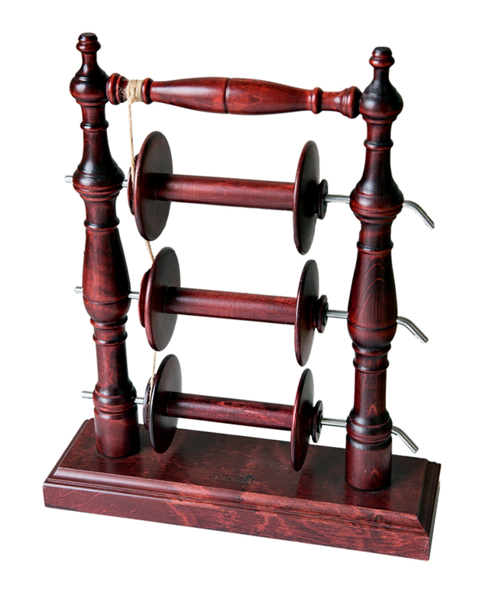 The Kromski Lazy Kate Arch by Kromski North America is a wooden spool holder with a dark stain finish, designed to hold six spools. It features two vertical columns on either side with intricate carvings, connected by three horizontal bars with tension control for ply yarn, standing on a rectangular base.