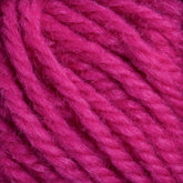 Close-up of several bright pink yarn strands tangled together, showcasing the texture and fibers of Halcyon Yarn Classic Rug Wool | Skein by Caledonian Dye Works. The yarn appears soft, thick, and slightly fuzzy—perfect for weavers seeking premium material.