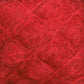 Close-up of a red textured surface, reminiscent of luxurious mohair. The fibers are tangled and crisscrossing, creating a pattern of intersecting lines and varied shades of red throughout. The texture looks soft and fluffy, much like the exquisite **Victorian Brushed Mohair Yarn | Large Skein** from **Caledonian Dye Works**.