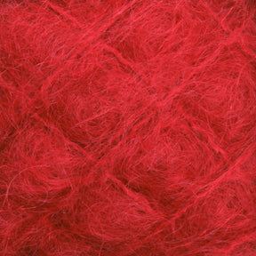 Close-up of a red textured surface, reminiscent of luxurious mohair. The fibers are tangled and crisscrossing, creating a pattern of intersecting lines and varied shades of red throughout. The texture looks soft and fluffy, much like the exquisite **Victorian Brushed Mohair Yarn | Large Skein** from **Caledonian Dye Works**.