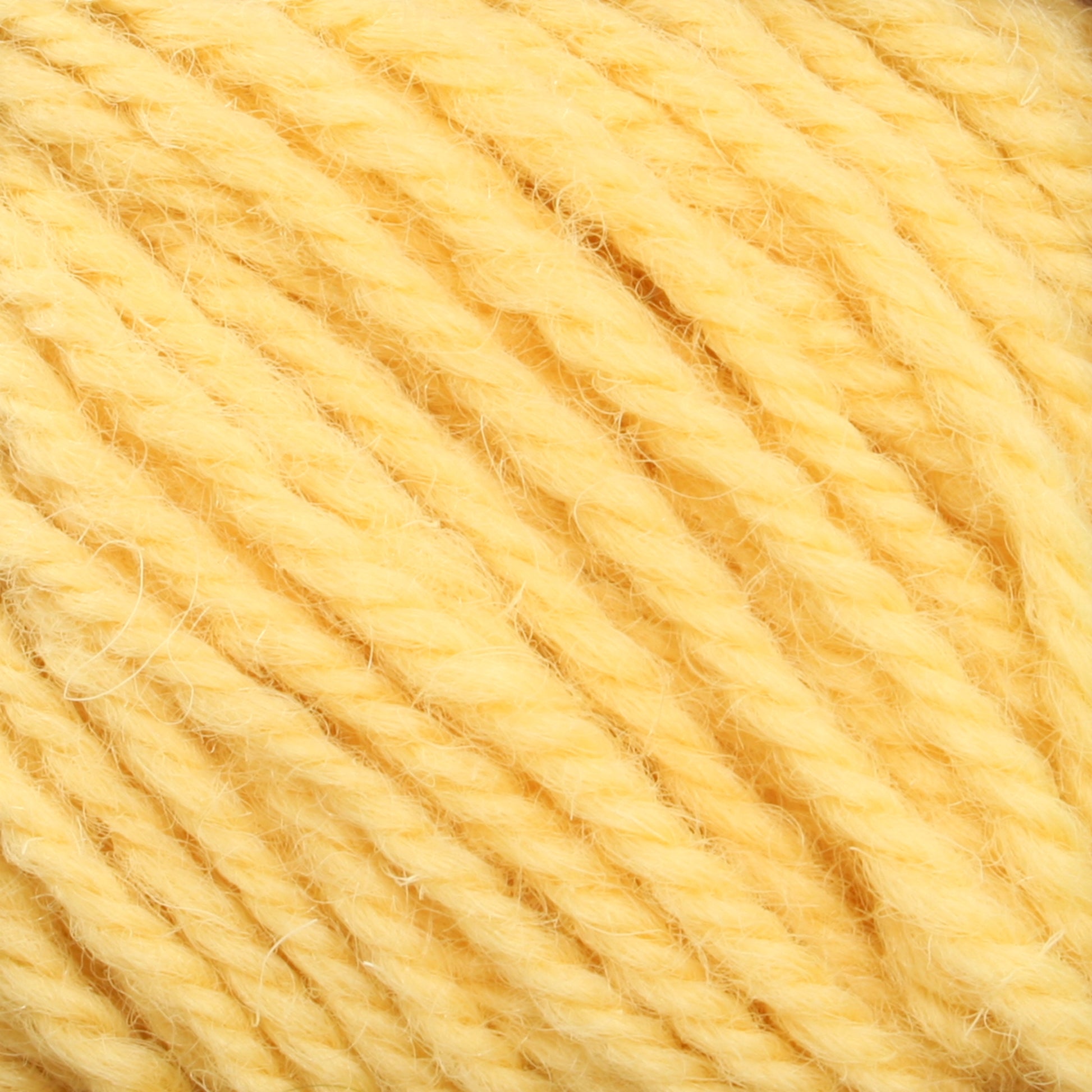 Close-up image of soft, yellow Halcyon Deco Rug Wool from Caledonian Dye Works with a twisted texture. The strands appear fluffy and intertwined, creating a thick, cozy appearance perfect for versatile yarn projects.