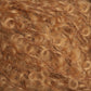 Close-up of light brown, curly hair or textured fibers. The curls are densely packed, giving a fluffy and voluminous appearance reminiscent of Caledonian Dye Works' Victorian Bouclé Mohair Yarn. The texture indicates a soft and springy quality from their Signature Victorian Collection.