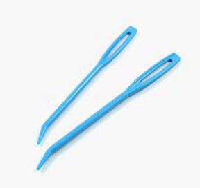 Two blue Plastic Jumbo Tapestry Needles from Accessories Unlimited, featuring large rectangular eyes for use with yarn or super bulky yarns, are placed diagonally on a white background. One needle has a slightly curved tip, while the other remains straight.