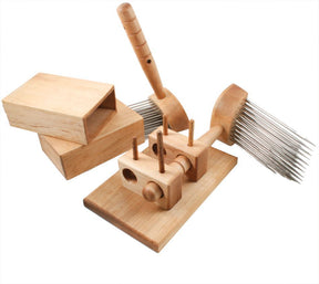 A perfect spinning kit, the Acorn Five Pitch Combs set by Sunrise Metal Works includes two wooden wool combs with long metal teeth, a handling base with wooden pegs, and a rectangular wooden box with a sliding lid. Ideal for fiber preparation, the combs and base ensure efficient processing of fibers.