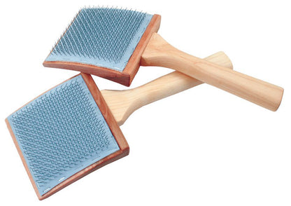 Two Schacht Mini Curved Carders - 72 PSI from Schacht Spindle Co., featuring rectangular heads with tightly packed, fine metal bristles and wooden handles, serve as all-purpose carding tools. One brush rests on top of the other, both positioned diagonally to showcase the bristles and handles.