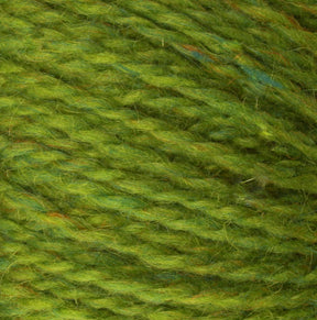 A close-up view of Harrisville Designs' Peace Fleece Yarn in green reveals subtle color variations and intertwined fibers. The texture appears soft and slightly fuzzy, indicating a warm and comfortable wool and mohair blend that's perfect for knitting or crafting projects.