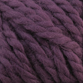 Close-up of thick, purple Baby Alpaca Grande by Plymouth yarn fibers from Plymouth Yarn Co. The ultra-soft fibers appear slightly fuzzy, tightly twisted together to form a chunky, textured surface. The color is a rich, deep shade of purple.