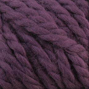 Close-up of thick, purple Baby Alpaca Grande by Plymouth yarn fibers from Plymouth Yarn Co. The ultra-soft fibers appear slightly fuzzy, tightly twisted together to form a chunky, textured surface. The color is a rich, deep shade of purple.