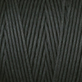 A close-up view of Stuart C. Hurlbert & Co.'s #9 Cotton Lacing Cord intricately wound into a ball. The dark gray cord is smooth and tightly arranged, creating a neat, diagonal pattern reminiscent of the precision seen in crafting braided rugs.