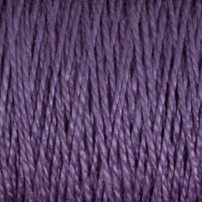 Close-up of a bundle of versatile Supreme Corp.'s 10/2 Pearl Cotton Yarn | Mini-cone in a rich purple hue. The texture of the yarn strands is clearly visible, showcasing intertwined fibers. The yarn appears soft and smooth, with consistent colorfastness throughout.