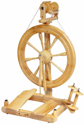 The Kromski Sonata Double-Treadle Spinning Wheel by Kromski North America is a traditional wooden spinning wheel that boasts a large wheel with multiple spokes. It features double treadles at the bottom and includes a bobbin and flyer assembly at the top. This portable Sonata spinning wheel is expertly designed for spinning fibers into yarn or thread.