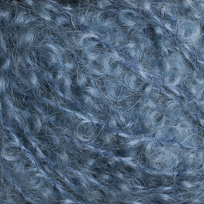 Close-up texture of light blue, curly knitting yarn from Caledonian Dye Works' Victorian Bouclé Mohair Yarn. The soft and fuzzy fibers form small, intricate loops with a slightly shiny appearance. This luxurious yarn is densely packed, creating a cozy and elegant look.