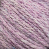 Close-up view of soft, heathered yarn featuring a mix of light pink, white, and subtle blue colors intertwined. The texture appears fluffy and slightly fuzzy, indicating a cozy and warm fabric suitable for knitting or crocheting with Harrisville Designs' Harrisville Highland - Cones unscoured yarn.