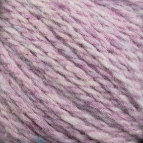 Close-up view of soft, heathered yarn featuring a mix of light pink, white, and subtle blue colors intertwined. The texture appears fluffy and slightly fuzzy, indicating a cozy and warm fabric suitable for knitting or crocheting with Harrisville Designs' Harrisville Highland - Cones unscoured yarn.