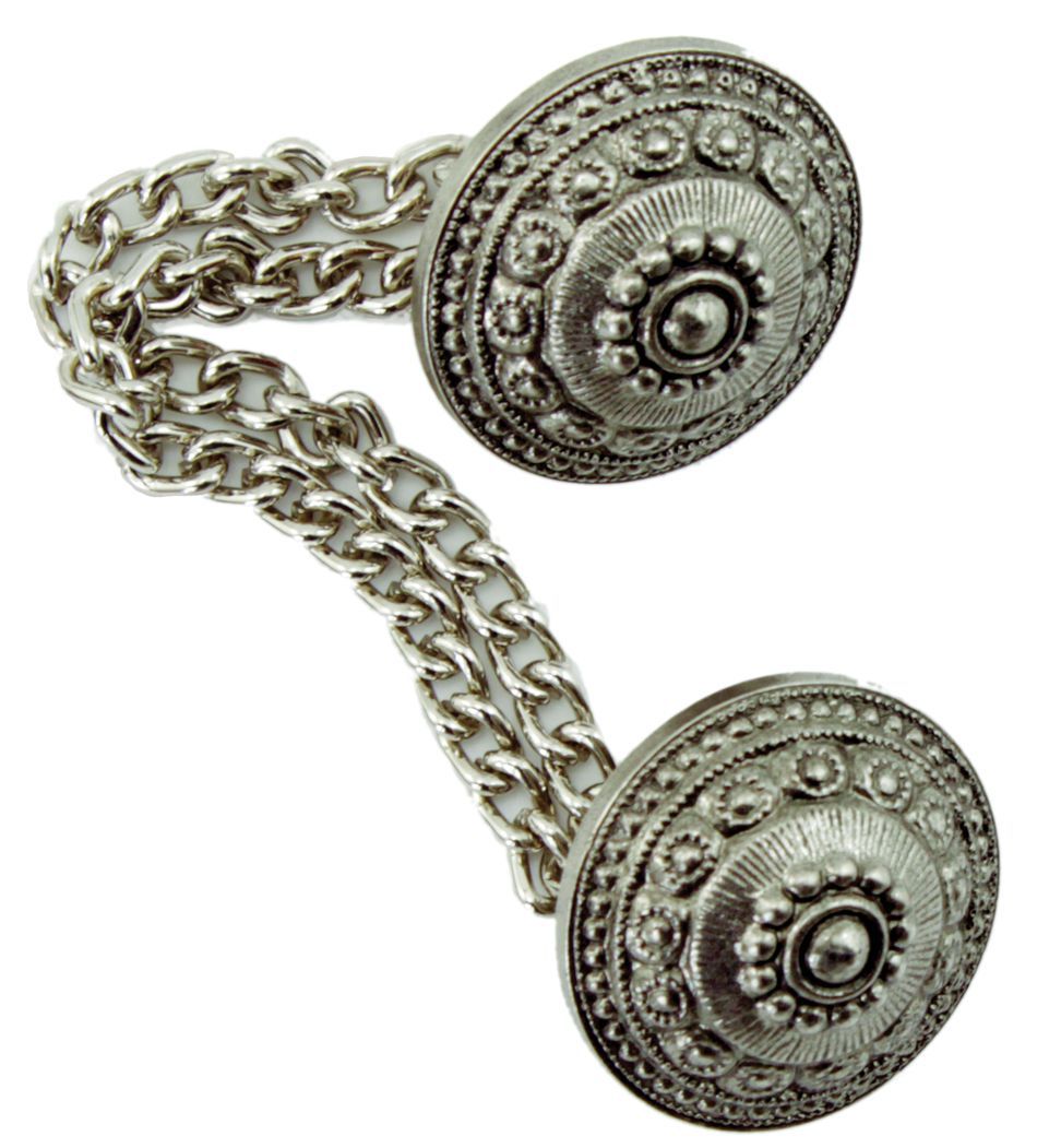 The Antiqued Silver Button with Chain 5/8" by Dill Buttons of America, Inc features an ornate pair of silver-tone button covers connected by delicate chains. Each cover, reminiscent of those found on Scandinavian sweaters, is round with intricate floral and geometric designs, creating a vintage and elegant appearance.