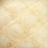 Close-up of the Victorian Brushed Mohair Yarn | Mini Skein from Caledonian Dye Works reveals a soft, fluffy, off-white surface with a grid of slightly darker lines. The texture is wispy and delicate, resembling luxurious mohair fibers. The crisscross pattern creates an intricate, tactile look.