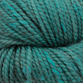 Close-up of thick, twisted teal Acadia by The Fibre Co. (UK) Ltd yarn. The texture is highly detailed, showcasing its fibrous material and subtle tweed effect with rich color variations.