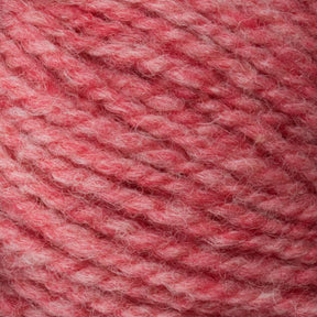 Close-up of a ball of Bartletts Maine Wool - Sport yarn with a soft, textured appearance. This sport weight yarn from Bartlettyarns features an inviting blend of pink and light red fibers, offering a cozy and warm feel.