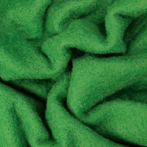 A close-up image of green fabric with a soft, fuzzy texture. The fabric appears to be Merino Prefelt by Europa Wools Ltd and is shown in a crumpled state, creating folds and shadows that emphasize its thickness and plush quality—perfect for felting projects.