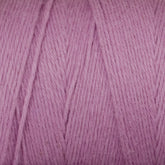 Close-up image of Maurice Brassard's Cotton 8/8 Carpet Warp in a soft, pink shade with a smooth texture. The strands are neatly wound, showcasing the fine, fibrous details and a consistent pastel hue throughout, perfect for knitting and crochet projects. This unmercerized cotton yarn adds a natural touch to your handmade creations.