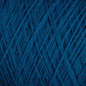 Close-up image of dark blue JaggerSpun Maine Line 2/20 Yarn from Jagger Brothers, Inc., showing detailed intertwining fibers and texture. The medium-grade wool threads are tightly wound, creating a dense and intricate pattern on the large cone.