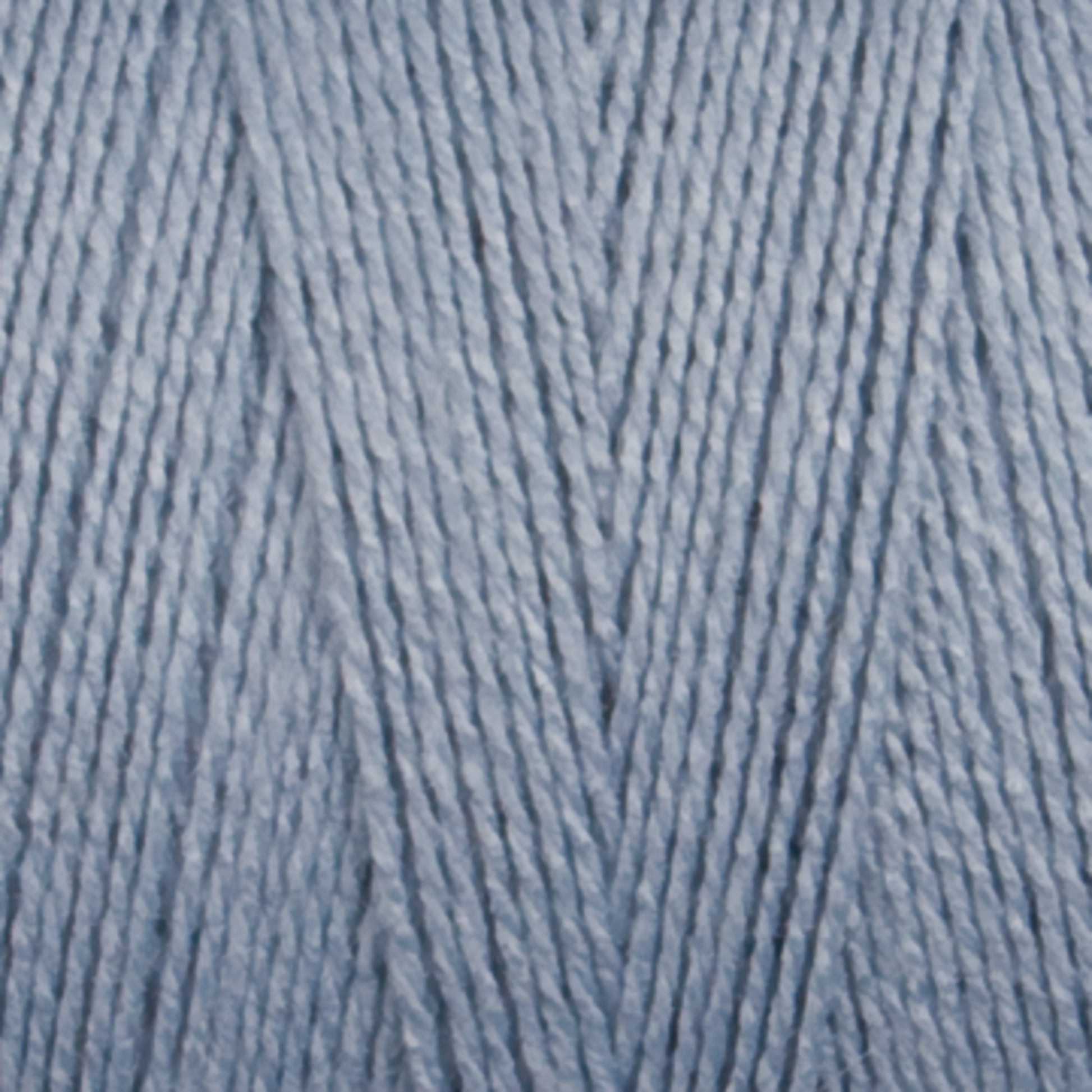 Close-up of soft, light blue 16/2 Bamboo Yarn by Maurice Brassard, neatly arranged in a parallel pattern, showcasing a smooth texture and a slightly shiny appearance. This sustainable yarn is suitable for knitting or crocheting projects and boasts antibacterial properties.