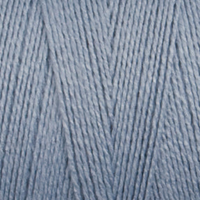 Close-up of soft, light blue 16/2 Bamboo Yarn by Maurice Brassard, neatly arranged in a parallel pattern, showcasing a smooth texture and a slightly shiny appearance. This sustainable yarn is suitable for knitting or crocheting projects and boasts antibacterial properties.