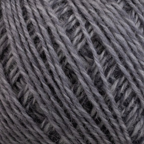 Close-up image of Knitting Fever Painted Desert Yarn by Euro Yarns, showcasing the intricate woven texture and soft fibers. The detailed view highlights the individual strands of this super fine weight yarn, which appears fuzzy and thick, making it ideal for knitting or crocheting lightweight accessories.