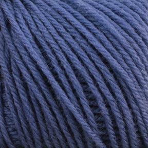 Close-up of Baby Blatt by Anny Blatt in blue, tightly wound into a ball, showcasing the soft and textured fibers in detail. This fingering weight, machine washable baby yarn from Essentially Felt Studio & Fine Yarn is perfect for delicate projects.