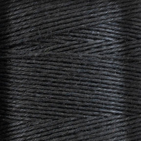 Close-up of 16/5 Linen Rug Lacing (Black) tightly wrapped around a mini-cone. The texture of the lacing, supplied by Stuart C. Hurlbert & Co., is clearly visible, with a slightly shiny surface and fine fibers intertwined. The image focuses on the details of the lacing's weave and surface, highlighting its smoothness and strength for crafting projects.