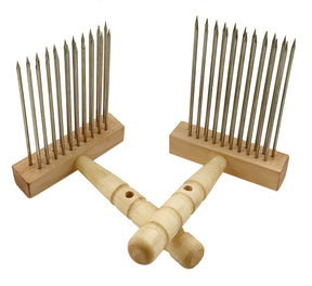 Two Acorn Double Row Viking Combs from Sunrise Metal Works, featuring metal tines for processing wool and finer fibers. Each comb boasts smooth wooden handles with two rows of long, evenly spaced metal teeth securely embedded in wooden bases. They are crossed with one comb resting on top of the other.