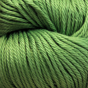 Close-up of a skein of green yarn, showing the texture and twisted strands of the fibers. Made from Cascade Ultra Pima Cotton Yarn by Cascade Yarns, the yarn has a smooth and slightly shiny surface, with a vibrant, grass-green color and an incredibly soft hand.