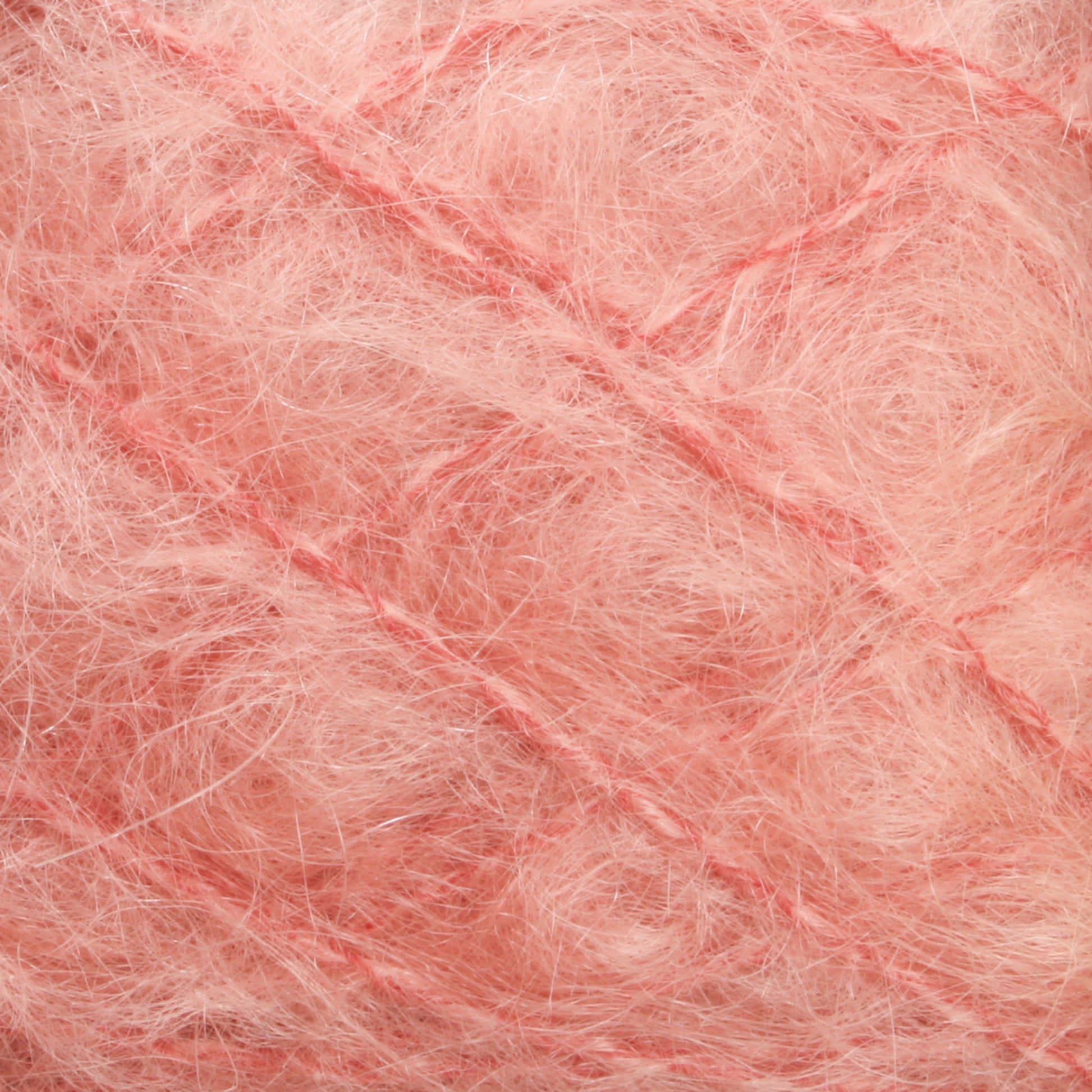 Close-up of the Victorian Brushed Mohair Yarn from Caledonian Dye Works. The soft, pink, fibrous texture appears fluffy and interwoven with crisscrossing threads, giving it a fuzzy, delicate appearance. This large skein has a plush and airy look, reminiscent of luxurious mohair or a mass of Victorian yarns.