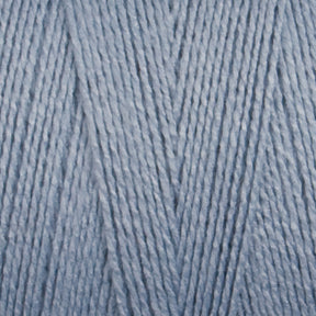 Here is a close-up of the Maurice Brassard 8/2 Tencel Yarn, Mini Cone in light blue. The yarn, known for its soft and smooth texture, has intricately wound strands that form a consistent and even surface. Ideal for weaving projects, it boasts a uniform color throughout and features a slightly glossy finish that reflects light beautifully.