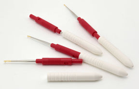 Five Skacel Capped Steel Crochet Hooks with white and red comfortable handles, each featuring a metal tip or hook. Three are fully extended, showcasing their tips, while two are partially retracted, and one is fully retracted into its handle. They are arranged diagonally on a white background.