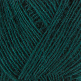 Close-up image of a ball of dark green Einband Lopi yarn by Berroco, Inc., showcasing intertwined threads. The texture and fibers, possibly Icelandic wool, are prominently visible, creating an intricate pattern of lines and loops. The overall appearance is soft and slightly fuzzy.