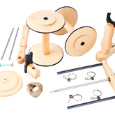 The Kromski Minstrel Wheel Great Flyer Set by Kromski North America features an assortment of wooden spools, rods, clamps, screws, and a piece of string, all arranged on a white background. These components appear to be for assembling a mechanical or craft project.