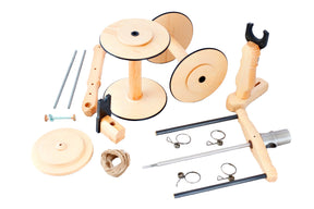 The Kromski Minstrel Wheel Great Flyer Set by Kromski North America features an assortment of wooden spools, rods, clamps, screws, and a piece of string, all arranged on a white background. These components appear to be for assembling a mechanical or craft project.