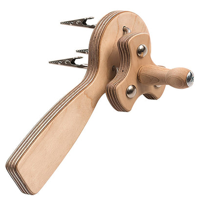 The Schacht Fringe Twister by Schacht Spindle Co. features a curvaceous handle and a wooden crosspiece, both crafted from layered, finished wood with a natural grain and smooth finish. The crosspiece includes two metal clips at the ends, designed for securing strings of a marionette.