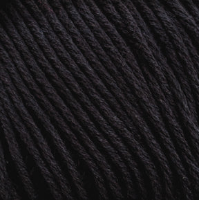 Close-up of a ball of Brown Sheep's Cotton Fleece with tightly wound fibers. The texture of the Cotton Fleece strands is clearly visible, showing a consistent and smooth pattern, perfect for intricate knitting patterns.